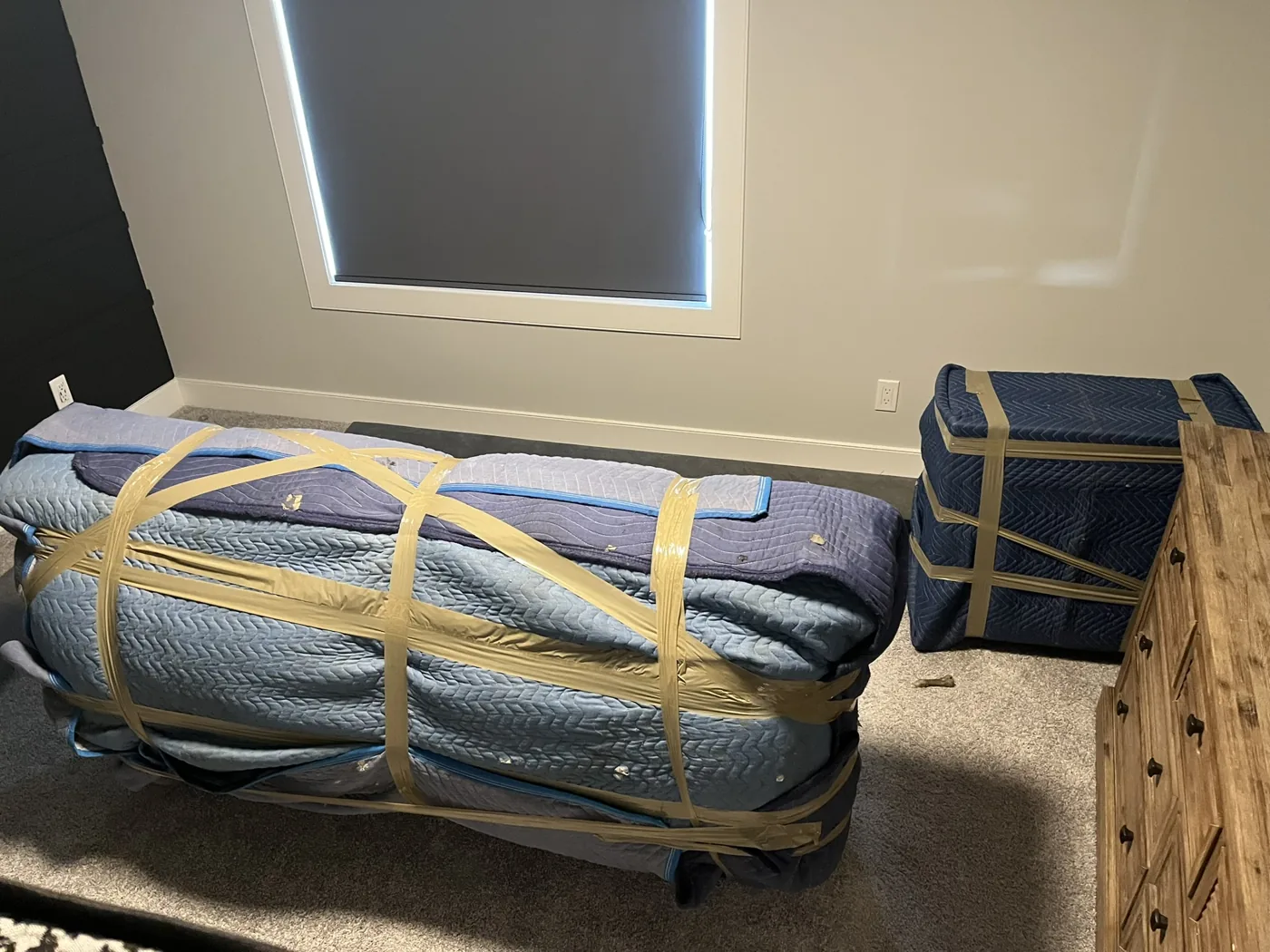 Sectional sofa blanket wrapped inside a home before loading